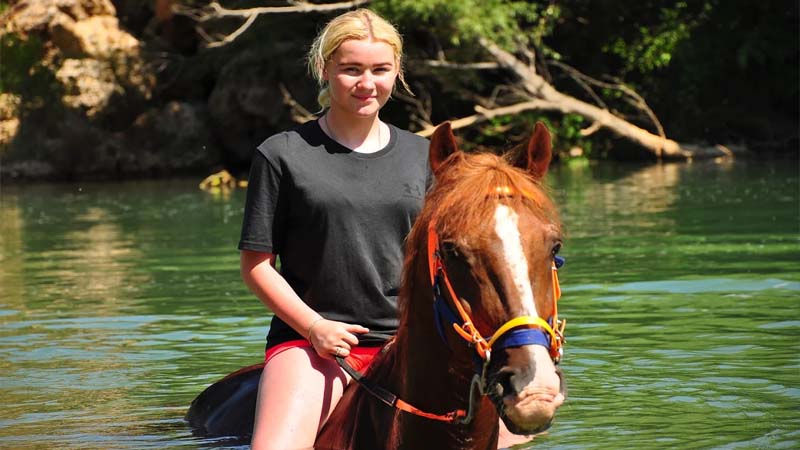 horse riding on river